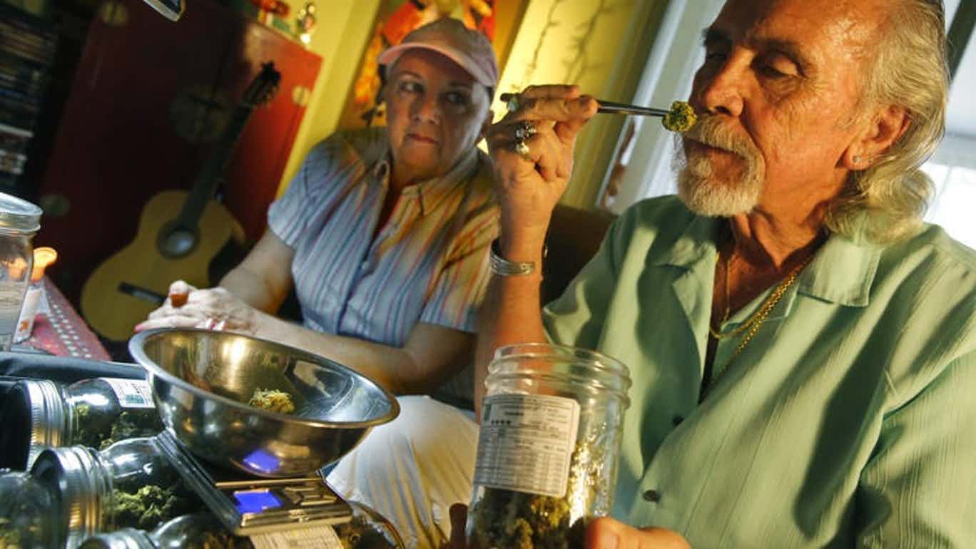 Older Couple with Man Smelling Cannabis