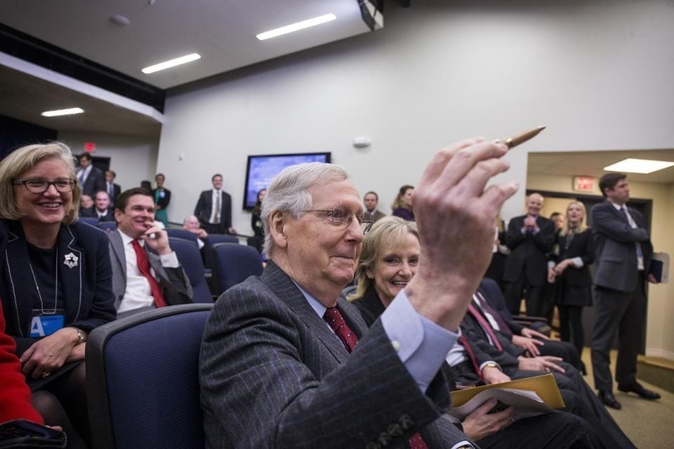 Senate Majority Leader Mitch McConnell, a Republican from Kentucky, holds a hemp pen before the start of a signing ceremony for H.R. 2, Agriculture Improvement Act of 2018, at the White House in Washington, D.C., U.S., on Thursday, Dec. 20, 2018. The Trump administration's aid package for U.S. farmers hurt by the trade war could end up saving some soybean acres next year. Photographer: Zach Gibson/Bloomberg© 2018 BLOOMBERG FINANCE LP